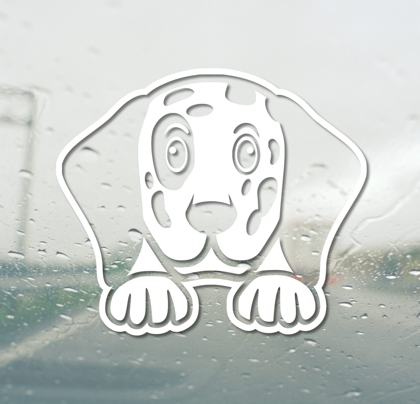 White dog-shaped window decal on a car window with raindrops.